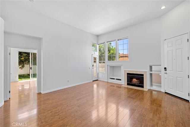 27884 Via De Costa, San Juan Capistrano, CA 92675 - unfurnished living room featuring healthy amount of natural light, wood-type flooring, a fireplace, and recessed lighting