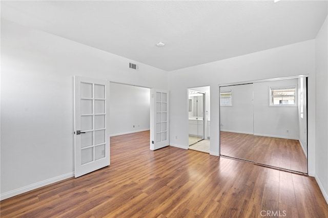 27884 Via De Costa, San Juan Capistrano, CA 92675 - unfurnished bedroom featuring french doors, wood finished floors, a closet, and ensuite bathroom