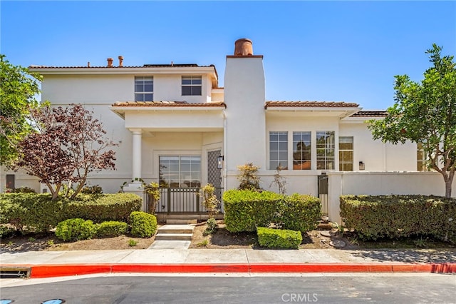 27884 Via De Costa, San Juan Capistrano, CA 92675 - mediterranean / spanish-style house featuring a chimney, solar panels, stucco siding, and a tiled roof