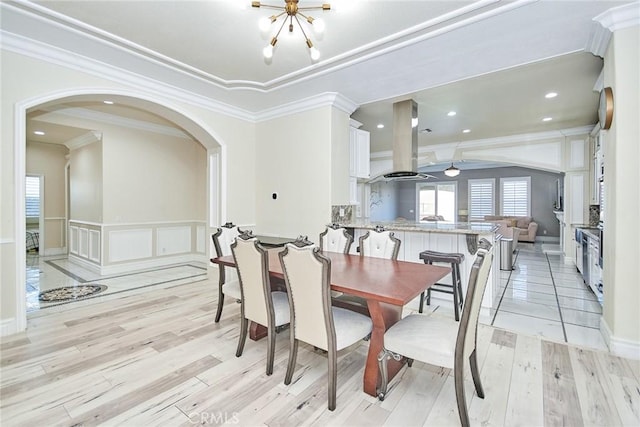 15446 Skyridge Dr, Riverside, CA 92503 - dining room featuring ornamental molding, arched walkways, light wood-type flooring, a decorative wall, and a ceiling fan