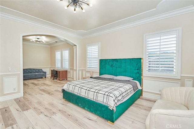 15446 Skyridge Dr, Riverside, CA 92503 - bedroom featuring a chandelier, arched walkways, ornamental molding, a wainscoted wall, and wood finished floors