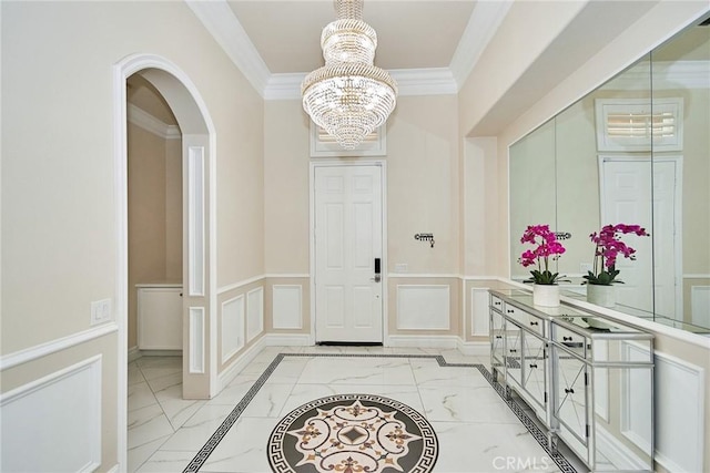 15446 Skyridge Dr, Riverside, CA 92503 - foyer entrance featuring a decorative wall, a chandelier, crown molding, arched walkways, and light marble finish flooring