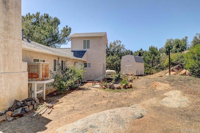 1242 Marshall Rd, Alpine, CA 91901 - back of house with a storage shed and stucco siding