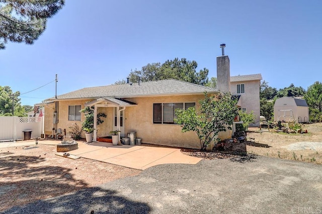 1242 Marshall Rd, Alpine, CA 91901 - rear view of house with stucco siding, a patio, and a chimney