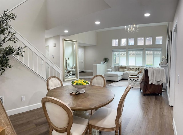 13425 Via Almeria, Tustin, CA 92782 - dining room with wood finished floors, stairs, a chandelier, a towering ceiling, and recessed lighting