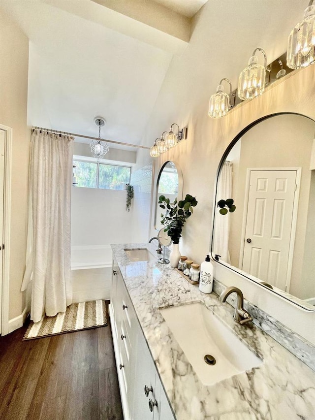 13425 Via Almeria, Tustin, CA 92782 - full bathroom featuring a chandelier, double vanity, wood finished floors, shower / tub combo with curtain, and high vaulted ceiling