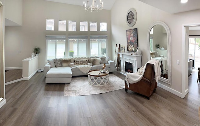 13425 Via Almeria, Tustin, CA 92782 - living area with wood finished floors, a high ceiling, a glass covered fireplace, and a chandelier