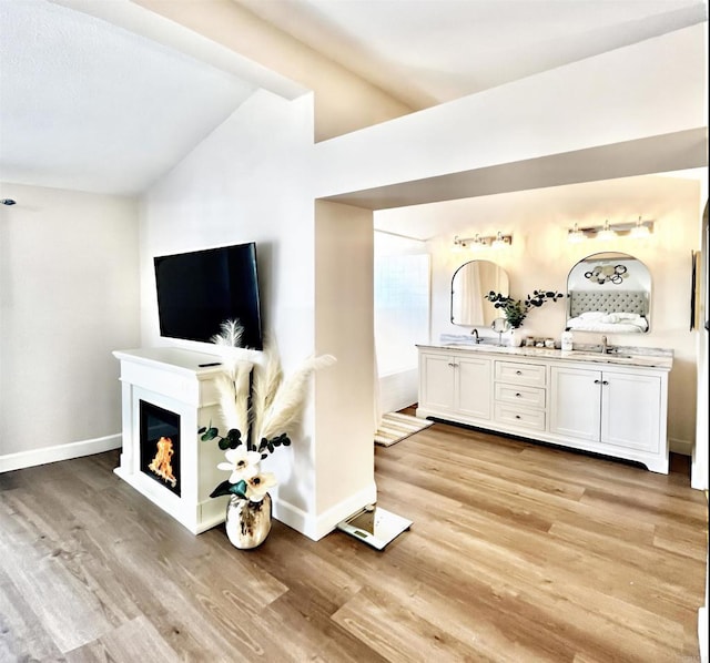 13425 Via Almeria, Tustin, CA 92782 - living room featuring vaulted ceiling, light wood finished floors, and a glass covered fireplace