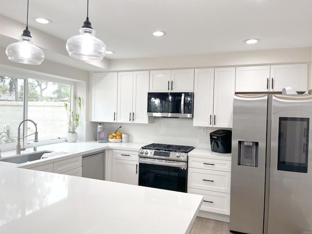 13425 Via Almeria, Tustin, CA 92782 - kitchen with stainless steel appliances, light countertops, white cabinets, decorative light fixtures, and recessed lighting