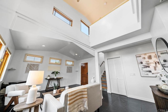 7439 Carrie Ridge Way, San Diego, CA 92139 - living area with stairway, plenty of natural light, dark tile patterned floors, and high vaulted ceiling