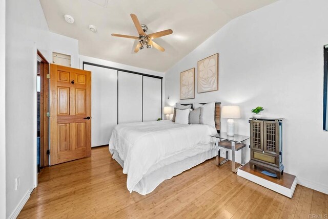 7439 Carrie Ridge Way, San Diego, CA 92139 - bedroom with vaulted ceiling, a closet, light wood-style floors, and ceiling fan