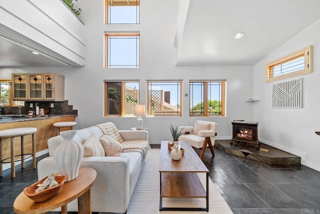 7439 Carrie Ridge Way, San Diego, CA 92139 - living area featuring a towering ceiling, healthy amount of natural light, a wood stove, and recessed lighting