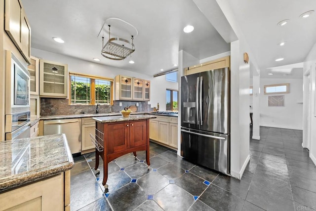 7439 Carrie Ridge Way, San Diego, CA 92139 - kitchen with appliances with stainless steel finishes, tasteful backsplash, glass insert cabinets, a kitchen island, and recessed lighting