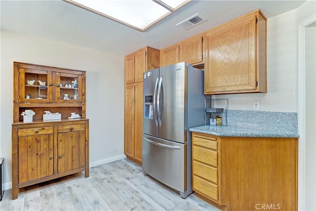 1255 S Upland Hills Dr S, Upland, CA 91786 - kitchen with stainless steel fridge, light wood-style flooring, and light stone counters