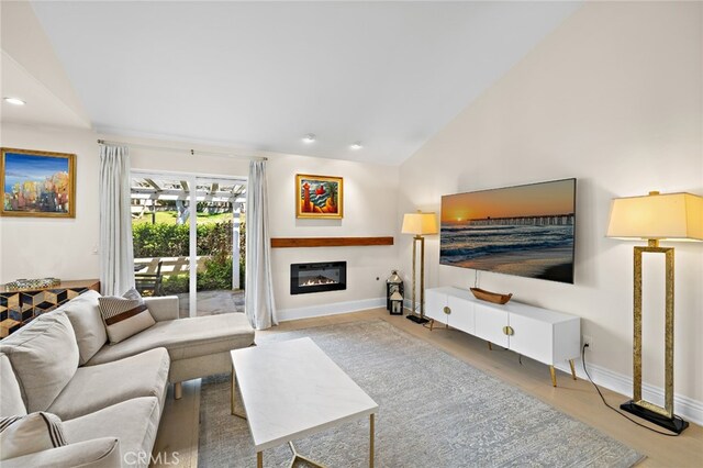 2719 Vista Umbrosa, Newport Beach, CA 92660 - living room featuring a glass covered fireplace, vaulted ceiling, and recessed lighting