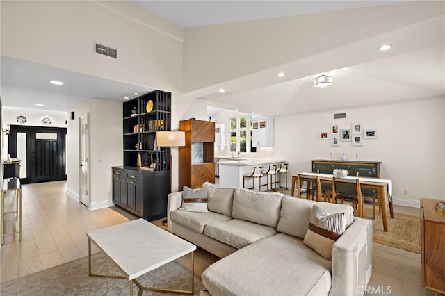 2719 Vista Umbrosa, Newport Beach, CA 92660 - living area with lofted ceiling, light wood-style flooring, and recessed lighting