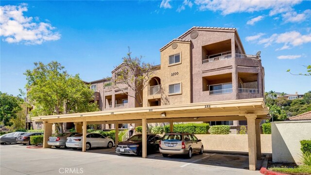 2500 San Gabriel Way Unit 306, Corona, CA 92882 - view of property featuring covered parking