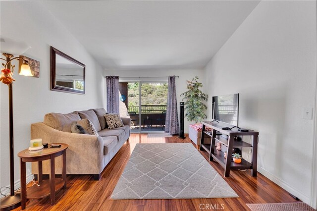 2500 San Gabriel Way Unit 306, Corona, CA 92882 - living area featuring wood finished floors and lofted ceiling