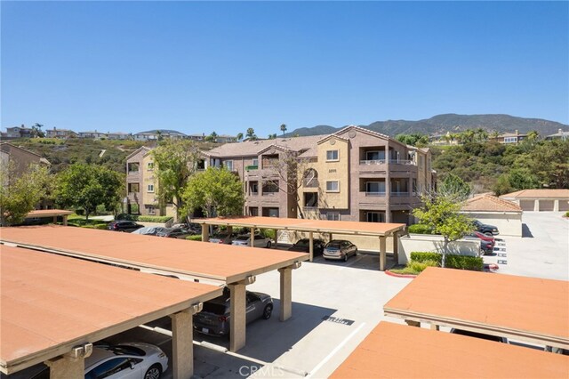 2500 San Gabriel Way Unit 306, Corona, CA 92882 - view of property featuring covered and uncovered parking and a mountain view