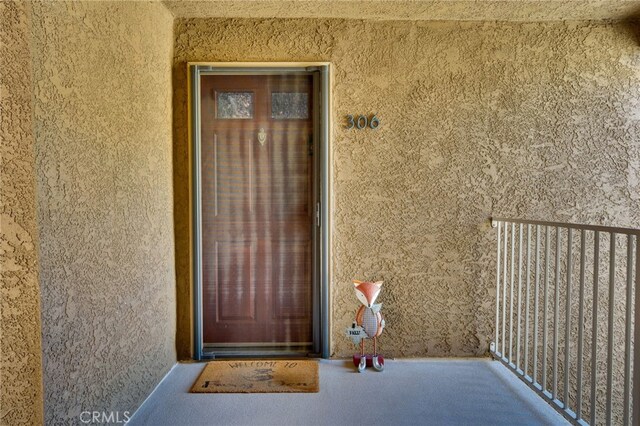 2500 San Gabriel Way Unit 306, Corona, CA 92882 - doorway to property featuring stucco siding and a balcony