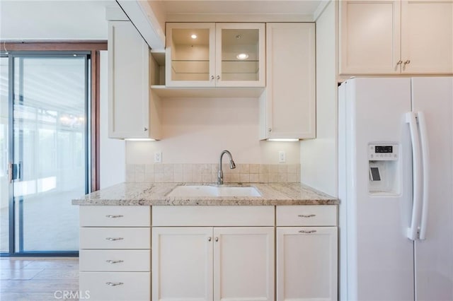 2605 Robinson St, Redondo Beach, CA 90278 - kitchen with white fridge with ice dispenser, white cabinetry, and light stone countertops