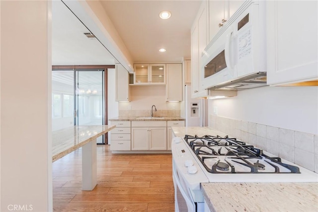 2605 Robinson St, Redondo Beach, CA 90278 - kitchen with white appliances, white cabinetry, light wood-style floors, recessed lighting, and light stone countertops