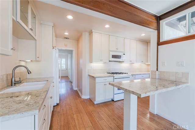 2605 Robinson St, Redondo Beach, CA 90278 - kitchen featuring white appliances, white cabinetry, light stone counters, and recessed lighting