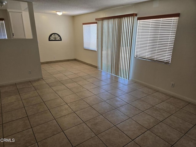 45409 Rodin Ave, Lancaster, CA 93535 - tiled spare room featuring a textured ceiling and baseboards