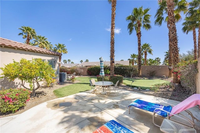 60284 Honeysuckle St, La Quinta, CA 92253 - fenced backyard with a patio area, a putting area, and outdoor dining area