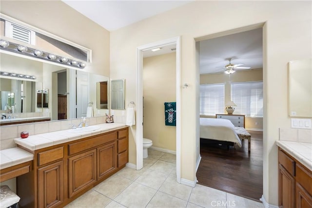 60284 Honeysuckle St, La Quinta, CA 92253 - ensuite bathroom featuring a ceiling fan, vanity, and tile patterned flooring