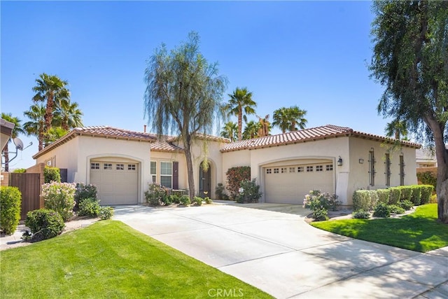 60284 Honeysuckle St, La Quinta, CA 92253 - mediterranean / spanish-style home featuring an attached garage, concrete driveway, stucco siding, and a tile roof