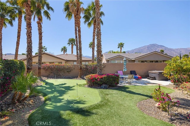 60284 Honeysuckle St, La Quinta, CA 92253 - fenced backyard with a hot tub, a putting area, a patio, and a mountain view