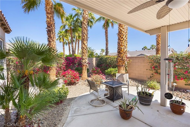60284 Honeysuckle St, La Quinta, CA 92253 - fenced backyard with a ceiling fan, a patio area, and a fire pit