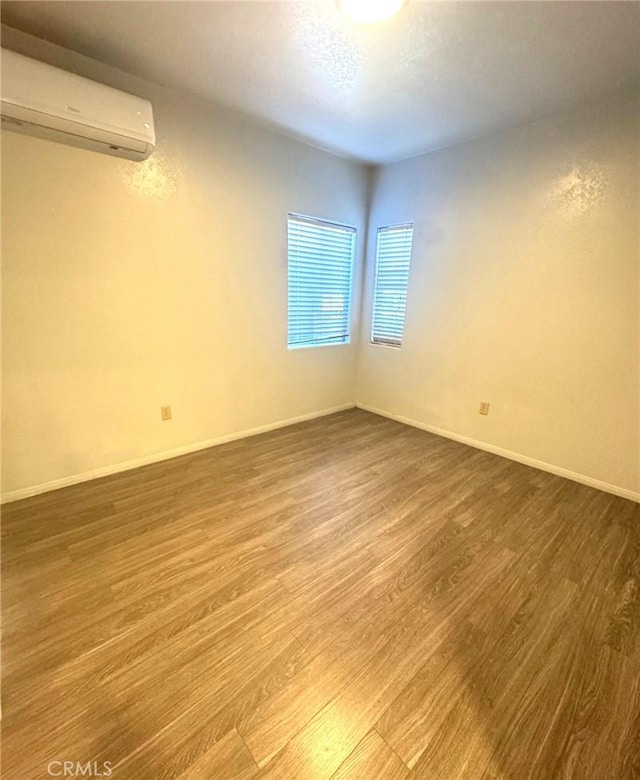 7892 8th St, Buena Park, CA 90621 - unfurnished room featuring a wall mounted air conditioner and wood finished floors