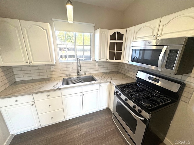 7892 8th St, Buena Park, CA 90621 - kitchen with stainless steel appliances, light stone countertops, tasteful backsplash, white cabinets, and dark wood-style floors