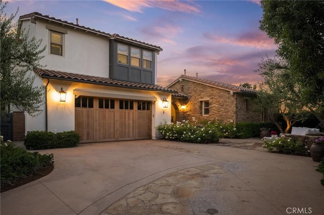 3 Stockmen Rd, Ladera Ranch, CA 92694 - mediterranean / spanish-style house with a tile roof, concrete driveway, a garage, stucco siding, and stone siding