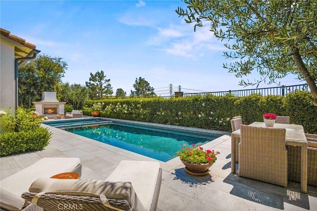 3 Stockmen Rd, Ladera Ranch, CA 92694 - view of pool featuring a lit fireplace and a patio