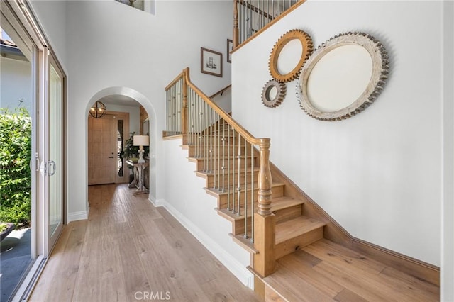 3 Stockmen Rd, Ladera Ranch, CA 92694 - stairway with arched walkways, wood finished floors, and a high ceiling