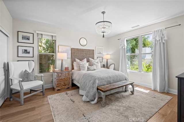 3 Stockmen Rd, Ladera Ranch, CA 92694 - bedroom with light wood-type flooring and a chandelier