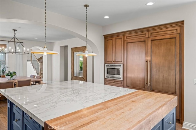 3 Stockmen Rd, Ladera Ranch, CA 92694 - kitchen featuring stainless steel microwave, arched walkways, a chandelier, decorative light fixtures, and recessed lighting