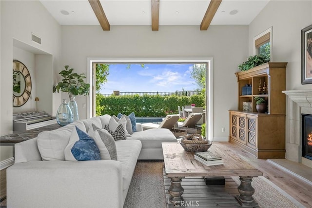 3 Stockmen Rd, Ladera Ranch, CA 92694 - living area with light wood finished floors, a glass covered fireplace, and beam ceiling