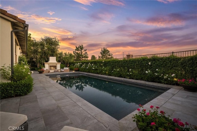 3 Stockmen Rd, Ladera Ranch, CA 92694 - view of pool with a warm lit fireplace and a patio area
