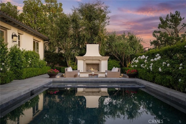 3 Stockmen Rd, Ladera Ranch, CA 92694 - swimming pool featuring a lit fireplace and a patio