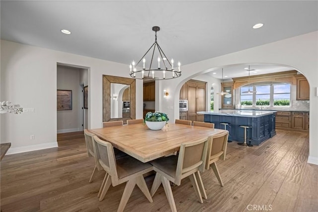 3 Stockmen Rd, Ladera Ranch, CA 92694 - dining room featuring arched walkways, a chandelier, light wood-style floors, and recessed lighting