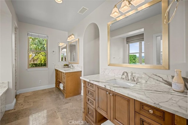 3 Stockmen Rd, Ladera Ranch, CA 92694 - full bathroom with healthy amount of natural light, two vanities, and stone finish flooring