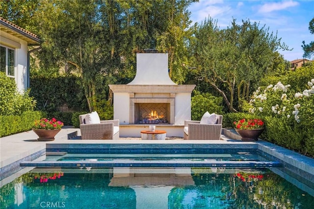 3 Stockmen Rd, Ladera Ranch, CA 92694 - view of swimming pool with a patio area, a pool with connected hot tub, and an outdoor living space with a fireplace