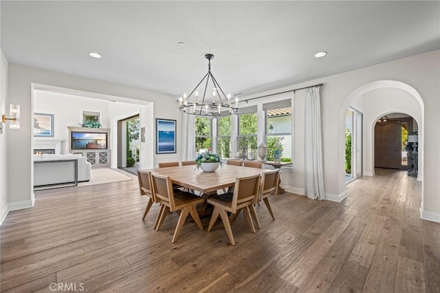 3 Stockmen Rd, Ladera Ranch, CA 92694 - dining area featuring a chandelier, arched walkways, wood finished floors, healthy amount of natural light, and recessed lighting