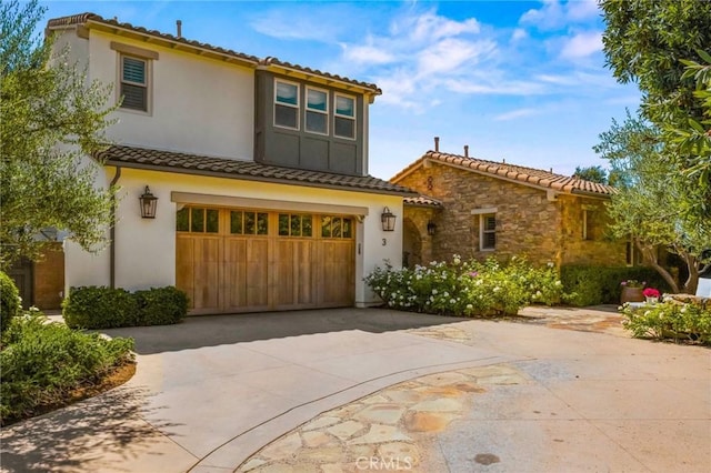 3 Stockmen Rd, Ladera Ranch, CA 92694 - mediterranean / spanish-style home with a garage, concrete driveway, a tile roof, stone siding, and stucco siding