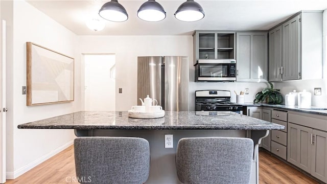 29282 Pine Dr, Cedar Glen, CA 92321 - kitchen featuring stainless steel appliances, gray cabinetry, open shelves, and a breakfast bar