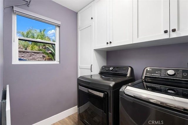 15 Surfbird Ln, Aliso Viejo, CA 92656 - laundry area with washer and clothes dryer, cabinet space, and light wood-style flooring